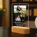 LED acrylic photo frame with two photos, warm glow border and circular wood base