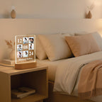 LED acrylic photo frame with 3 photo slots, glowing white outline on a bedside table