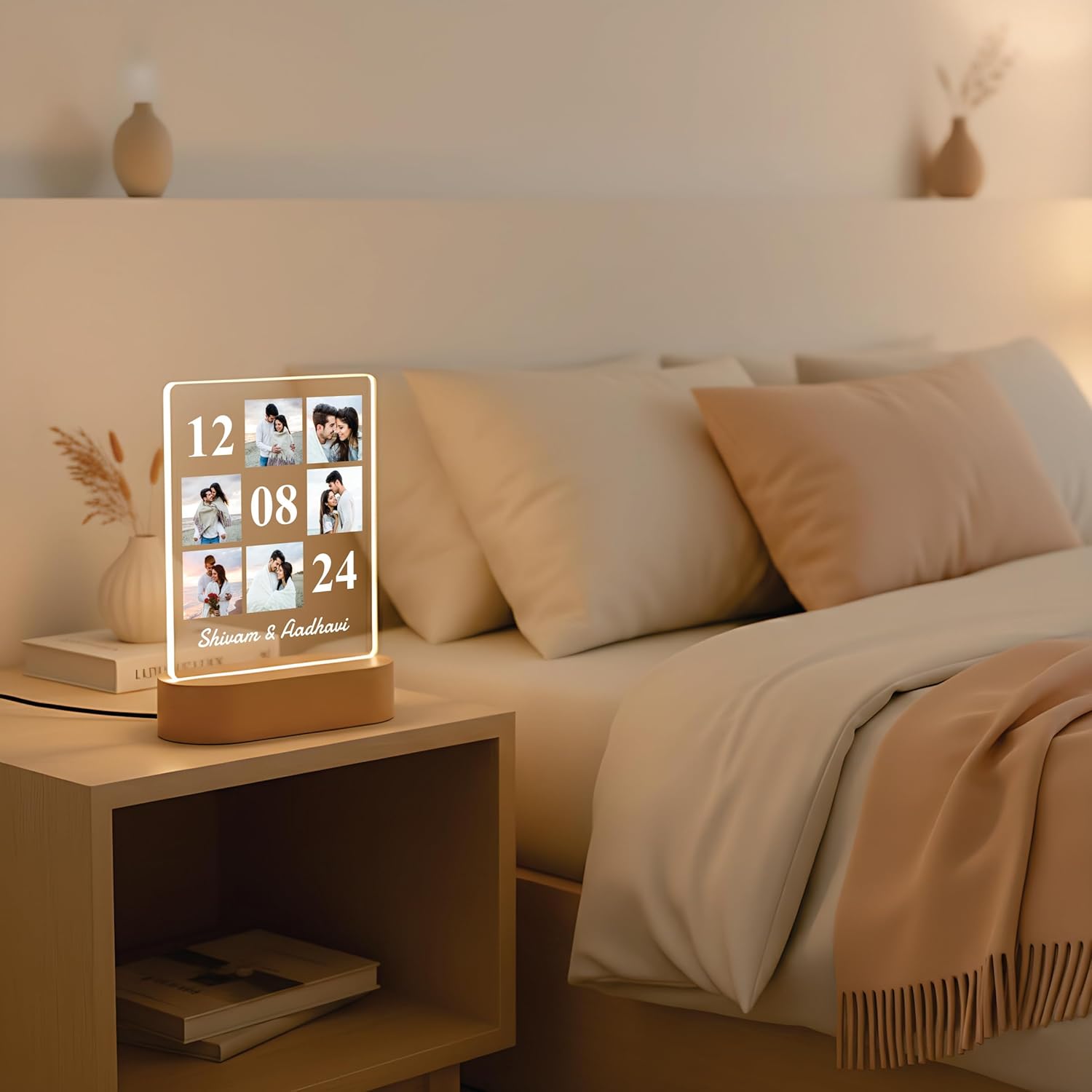 LED acrylic photo frame with 3 photo slots, glowing white outline on a bedside table