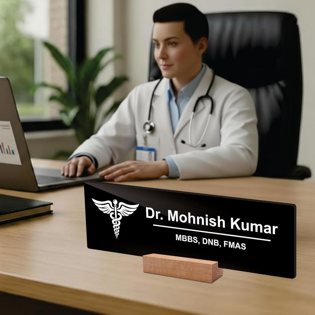 Black acrylic desk name plate with white doctor name, caduceus logo, and wooden stand