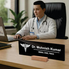 Black acrylic desk name plate with white doctor name, caduceus logo, and wooden stand