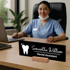 Black acrylic desk name plate with white tooth icon, name script, “Dental Assistant”, on wood stand
