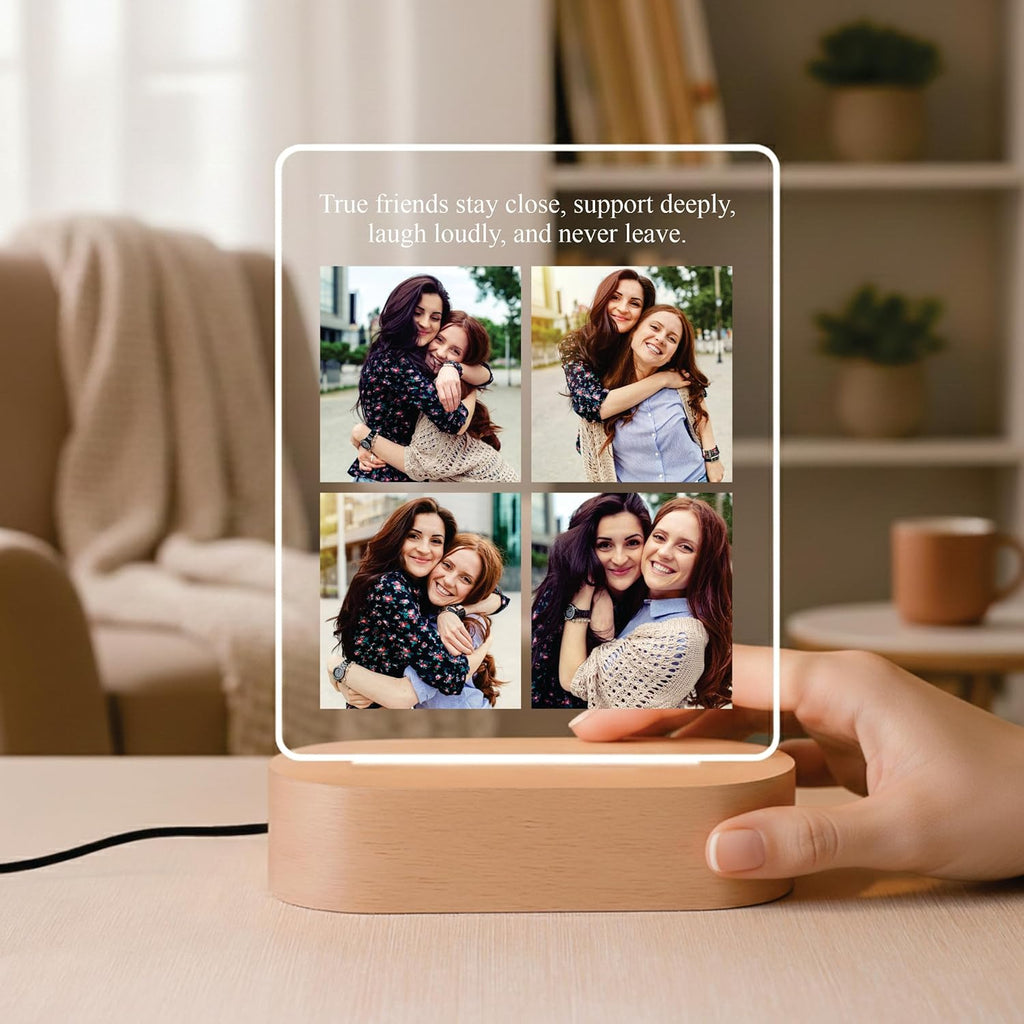 LED acrylic photo frame with warm glow and four-photo collage on wood base, held in hand