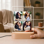LED acrylic photo frame with warm glow and four-photo collage on wood base, held in hand