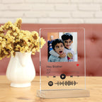 Acrylic photo frame with child portrait, Spotify controls, and wooden stand