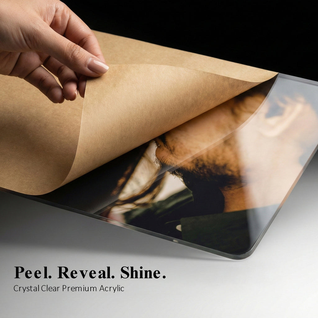 Acrylic photo frame with clear protective film being peeled off, revealing print