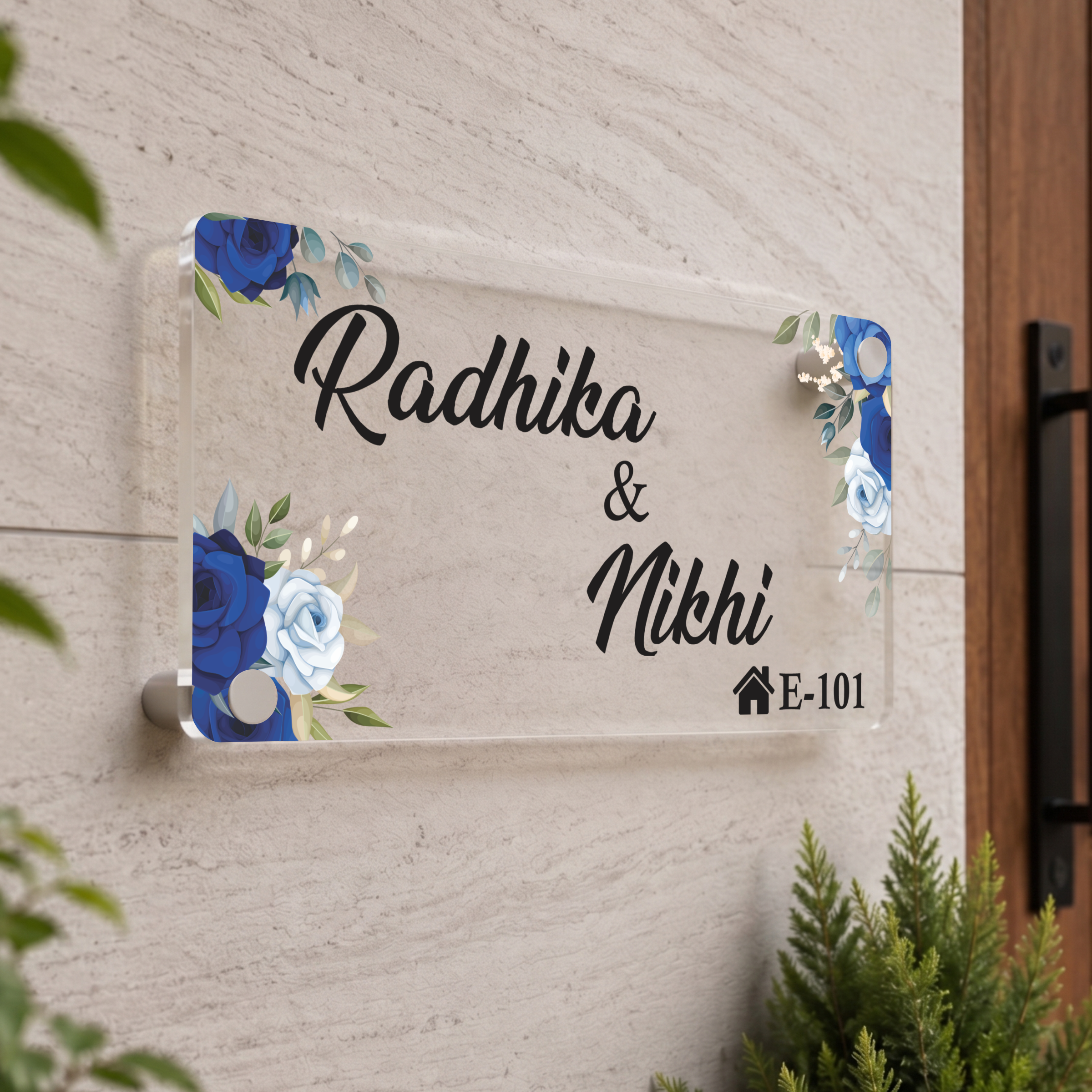 Transparent acrylic door name plate: Radhika & Nidhi, blue floral corners, E-101
