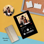 Black acrylic photo frame angled view with couple photo on wooden stand