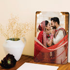 Clear acrylic wall photo frame leaning on a surface with a couple portrait
