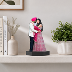 Personalized photo cutout display of couple in pink and white outfits on black base