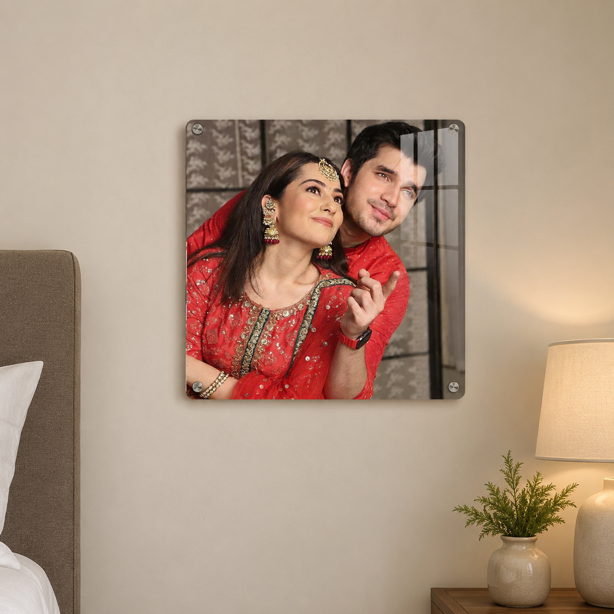 Square acrylic photo frame with rounded corners and metal corner mounts, showing a couple close-up
