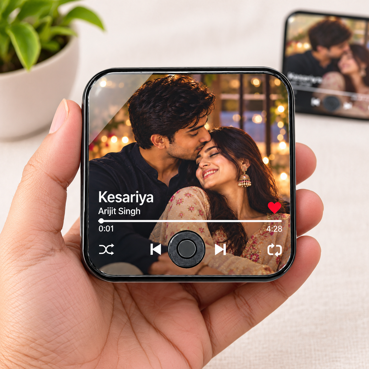 Music photo fridge magnet in hand showing photo on screen and playback controls