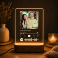 Glowing acrylic photo music frame with built-in audio controls under a photo panel
