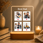 Edge-lit LED acrylic photo frame with four portrait tiles and warm light, on wood base